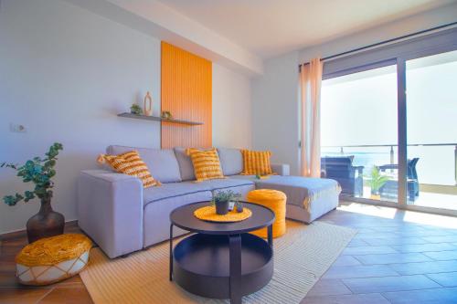 a living room with a couch and a table at Modern Central Seaview Apartment Saranda in Sarandë