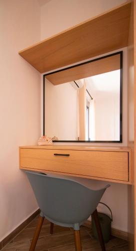 a dressing table with a mirror on top of it at Modern Central Seaview Apartment Saranda in Sarandë