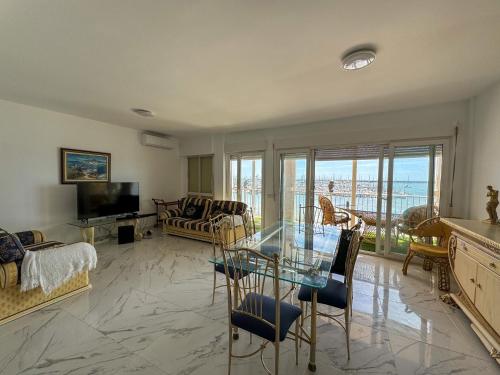 a living room with a glass table and a couch at Luxury Oceanfront Amazing view Playa del Acequion in Torrevieja