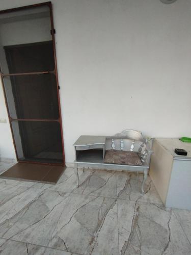a white room with a bench and a refrigerator at Guesthouse Ed&Er in Geghanist