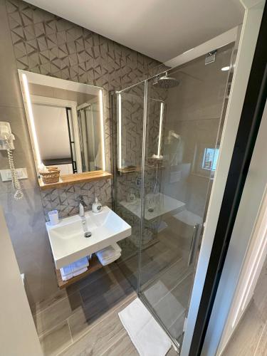 a bathroom with a sink and a shower at Žigon Bed & Breakfast in Logatec