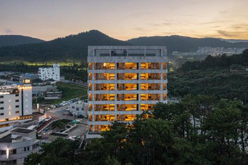 a tall building with lights on in a city at Ije Busan in Busan