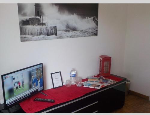 a desk with a computer and a television on it at FRAROCKA B and B in La Ciotat