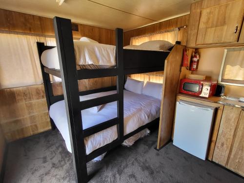 a bedroom with two bunk beds and a refrigerator at Kangaroo Lake C & C Park 