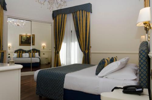 Postel nebo postele na pokoji v ubytování Hotel Traiano