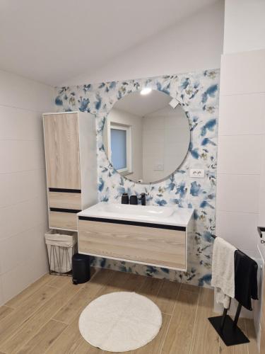 a bathroom with a sink and a mirror at Hiša Naj in Koper
