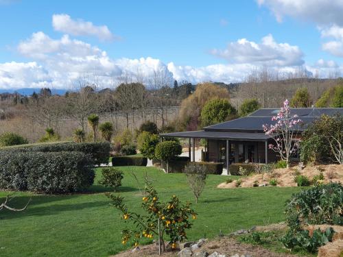 a house with a garden in front of it at Supplejack Gardens in Upper Moutere