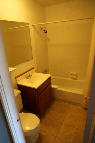 a bathroom with a sink and a toilet and a tub at Seatac Inn in SeaTac