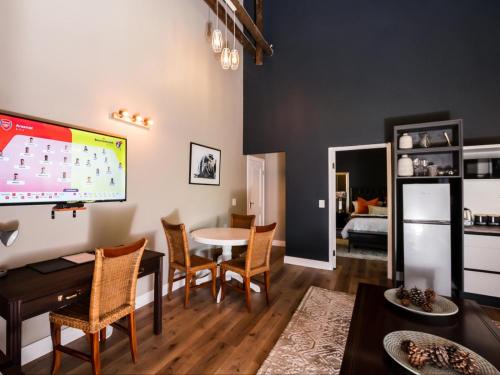 a living room with a table and chairs and a tv at Celtis Manor Guesthouse in Midrand