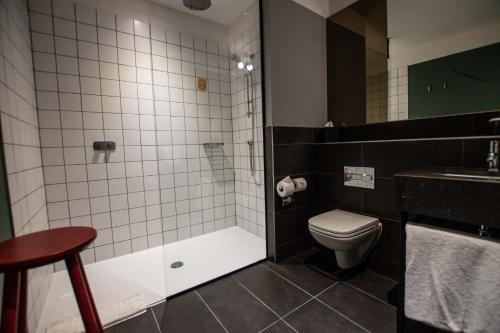 a bathroom with a shower and a toilet and a sink at Hotel Indigo - Dundee by IHG in Dundee