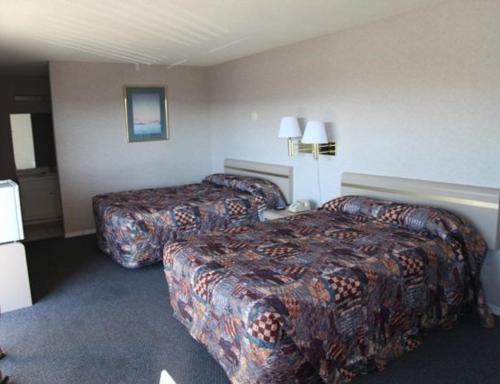a hotel room with two beds in a room at Seatac Inn in SeaTac