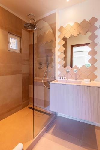 a bathroom with a shower and a sink at Lou Cagnard in Saint-Tropez