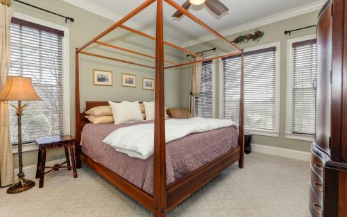1 dormitorio con cama con dosel y ventanas en Doctors Orders - Refresh and recharge with peaceful views and a cozy hot tub, en Marblehill