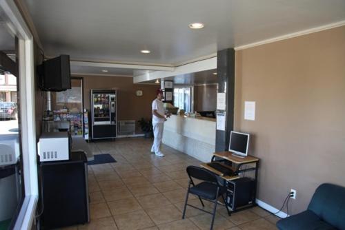 a man standing at a counter in a kitchen at Seatac Inn in SeaTac