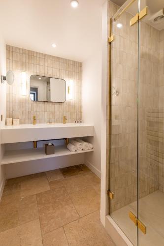 a bathroom with a sink and a shower at Lou Cagnard in Saint-Tropez
