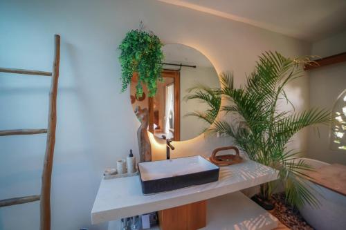 a bathroom with a sink and a mirror at Ubu Villa Padi's in Yogyakarta in Ngaglik