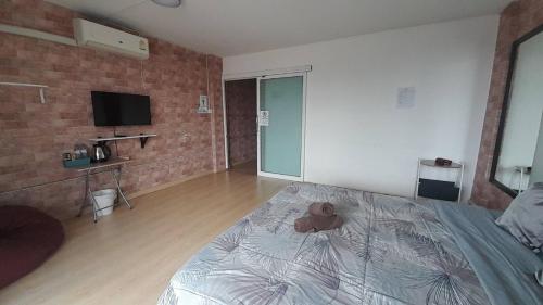 a bedroom with a bed with a doll on it at HOMEY-Sleepy Don Mueang Airport Hostel in Bangkok