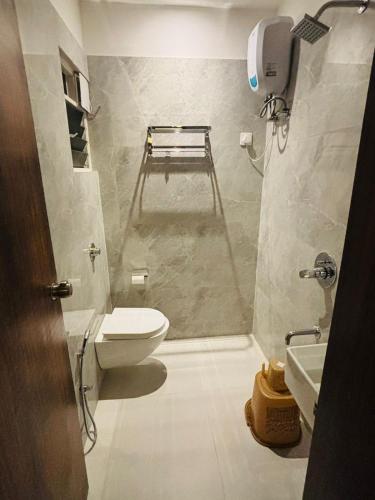 a small bathroom with a toilet and a sink at Hotel Relax Inn in Nagpur