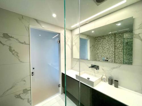 een badkamer met een wastafel en een spiegel bij Penthouse Luxury Apartment in Nicosia