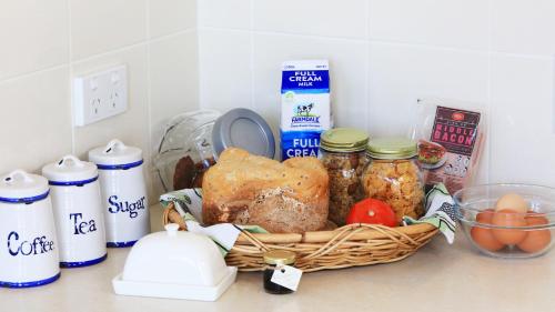 een mand met eten op een aanrecht met andere ingrediënten bij Grace Cottages in Uralla