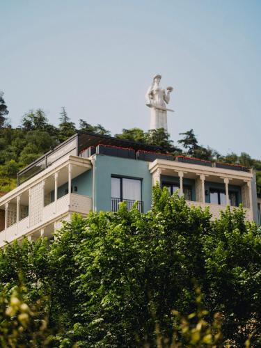 a building with a statue on top of it at Amante Narikala Boutique Hotel in Tbilisi City