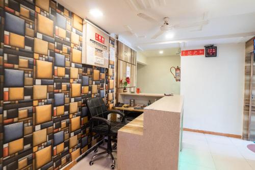 an office with a wall of squares on the wall at Flagship Hotel Swell in Ahmedabad