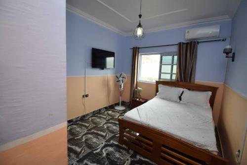 1 dormitorio con cama y ventana en Milk and Honey House en Limbe