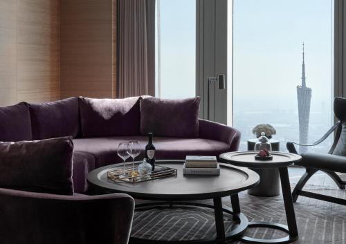 a living room with a purple couch and a table at Rosewood Guangzhou, enjoy free shuttle bus service between the hotel and the Canton Fair Complex during the Canton Fair in Guangzhou