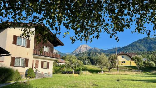 a house with a view of mountains in the background at Ferienhaus Faaker See 23 in Faak am See