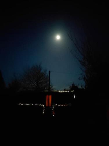 a moonlit night with a sign and lights in the dark at HH Haven in Roscrea
