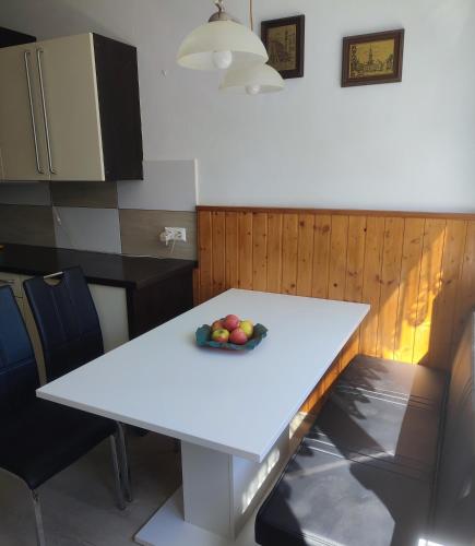 a white table with a bowl of fruit on it at Wohnung in St Poelten in Sankt Pölten