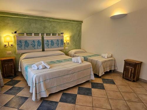 a hotel room with two beds in a room at Emerald Coast Hotel in Olbia