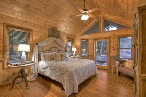 a bedroom with a bed and a ceiling fan at View-Topia STUNNING VIEWS - Hot tub - Gameroom in Blue Ridge
