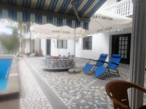 a group of blue chairs sitting in a courtyard at Vila Jovana A in Rogljevo