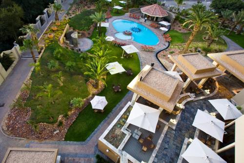 an aerial view of a resort with a pool and umbrellas at Mercure Hotel Windhoek in Windhoek