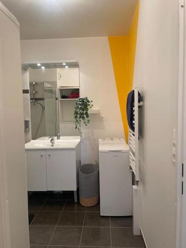 une salle de bain avec deux lavabos et un miroir dans l'établissement Appartement 3P Gare Terrasse et Parking privé, à Franconville