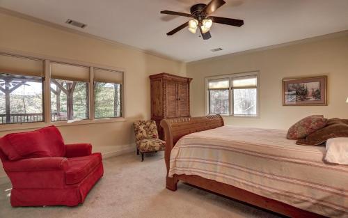 a bedroom with a bed and a ceiling fan and a chair at Mountain Memories - Viking gas range GE double ovenwarmer Lake views in Marblehill