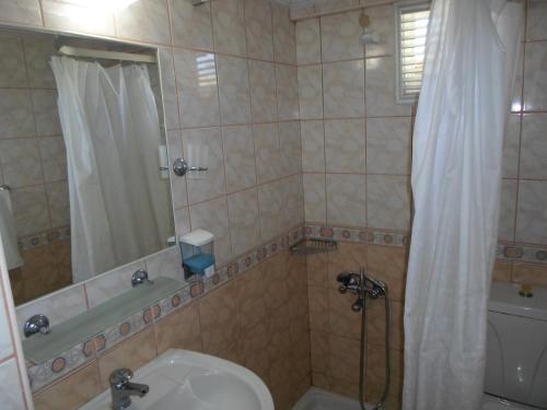 a bathroom with a shower and a toilet and a sink at Myra Hotel in Marmaris