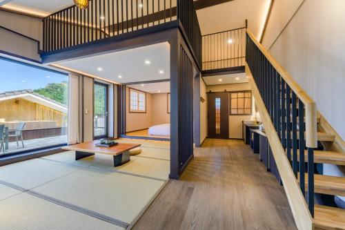 a room with a staircase leading to a bedroom at Hotel HaruSida in Seogwipo