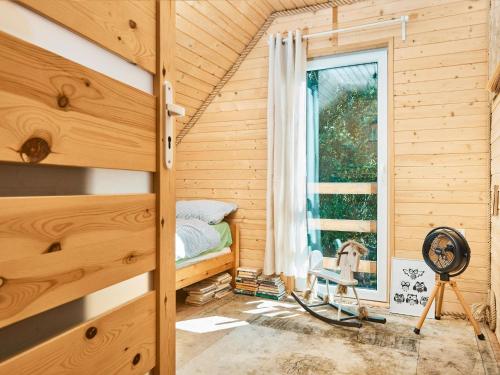 a small bedroom with a bed and a window at Holiday Home Nadole near Baltic Sea in Nadole