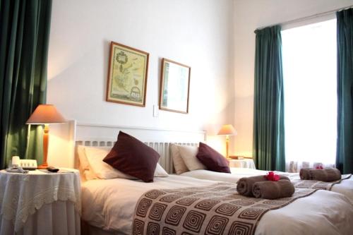 a hotel room with two beds with stuffed animals on them at Albertinia Hotel in Albertinia