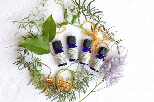 a group of four bottles of essential oils and plants at Imperial Hotel Tokyo in Tokyo