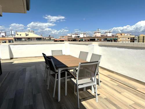 une table et des chaises au-dessus du toit dans l'établissement Pont de Fusta Apartments, à Valence