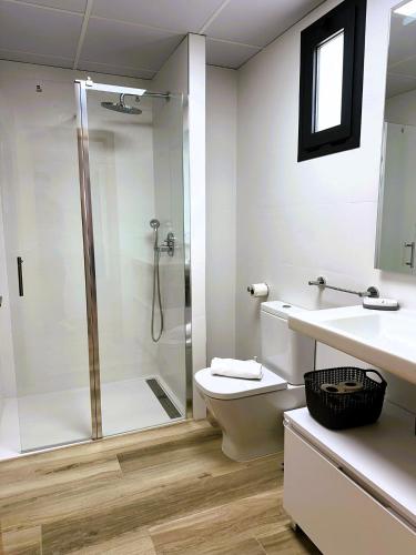 a bathroom with a shower and a toilet and a sink at MD Pont de Fusta in Valencia