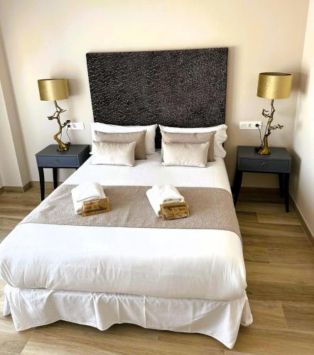 a bedroom with a large white bed with two night stands at MD Pont de Fusta in Valencia