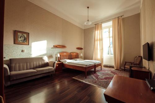 a living room with a couch and a table at Hotel Kaštieľ Mojmírovce in Mojmírovce
