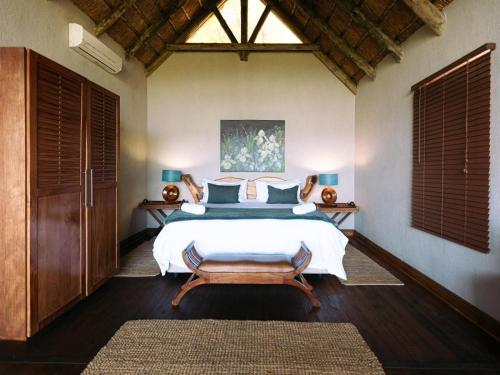 a bedroom with a large white bed and a window at Oluchi Lodge in Guthrie