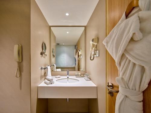 a bathroom with a sink and a mirror at Sayaji Pune in Pune