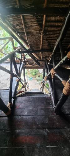 a view from the inside of a building with a roof at Salama & Mbuyuni Bungalows in Matemwe