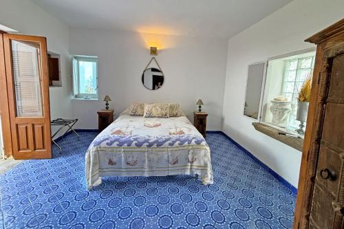 a bedroom with a bed with a blue floor at Casa Perla in Panarea